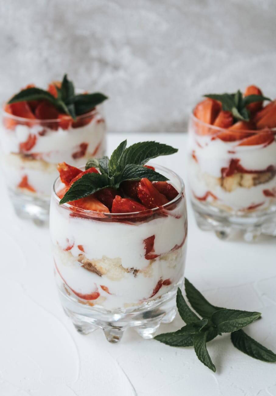 clear glasses with fresh strawberry and ice cream